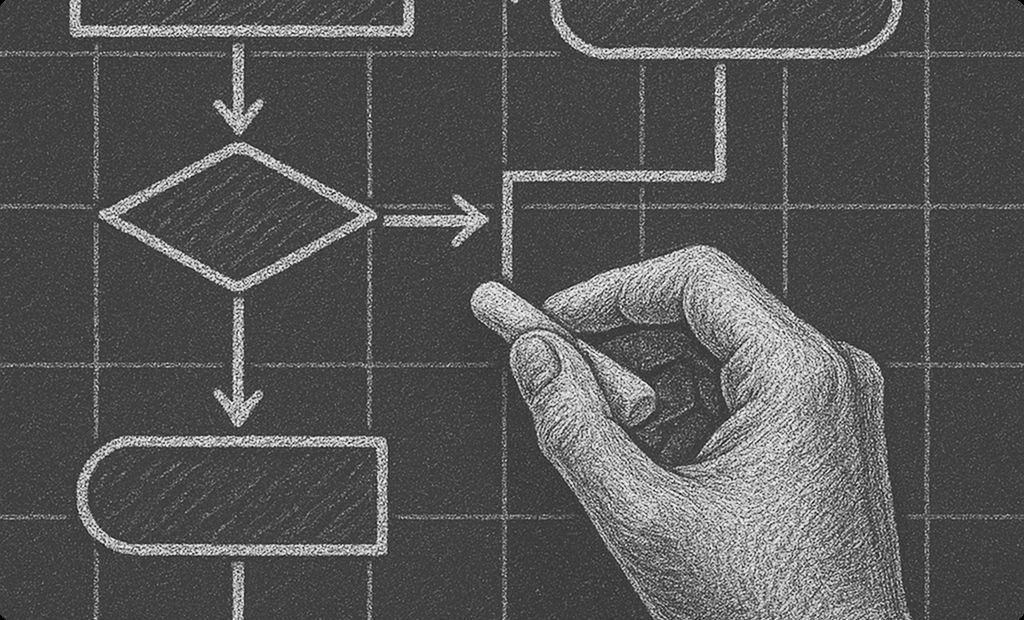 A hand drawing a process flowchart in chalk.