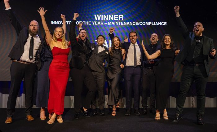 The Tapi team on stage at an awards night.